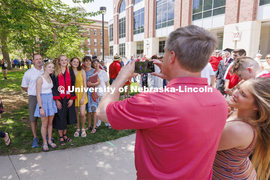 Morgan Heasty and family pose for photos following the UNL undergraduate commencement in Memorial Stadium. May 14, 2022. Photo by Craig Chandler / University Communication.