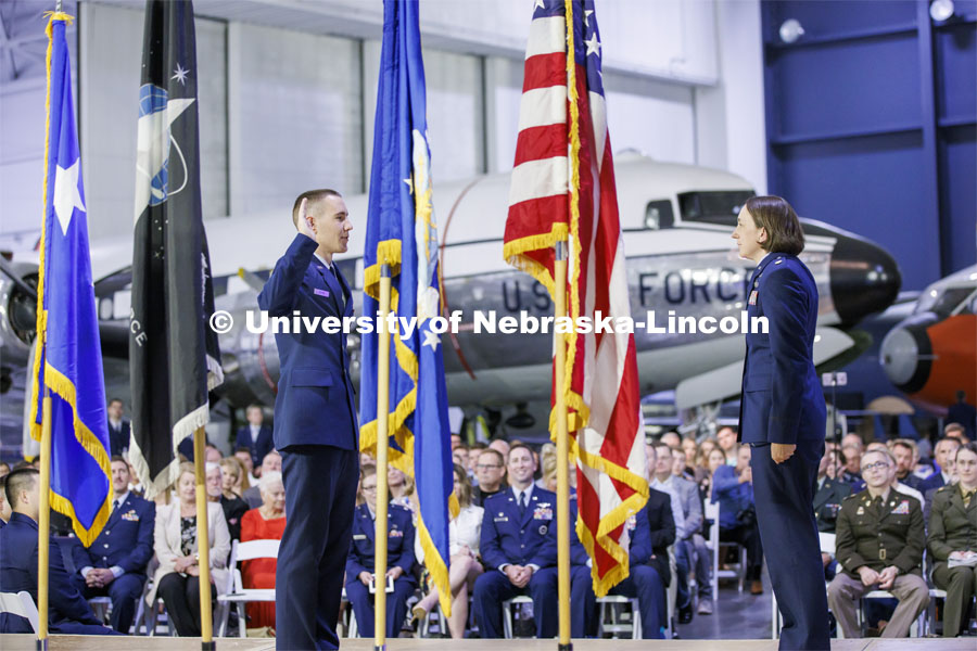 Second Lt. Lucas Heaton recites the Oath of Office as directed by Air Force Major Nicole Beebe on May 16. The university’s Air Force ROTC detachment held a commissioning for May graduates at the Strategic Air Command and Aerospace Museum in Ashland. In the background is a C-54. May 16, 2022. Photo by Craig Chandler / University Communication.