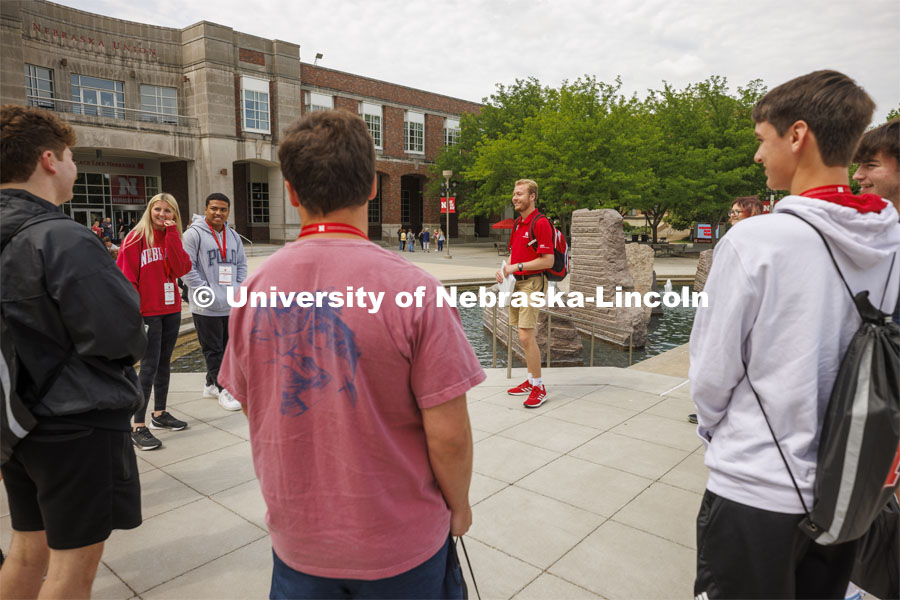 Jackson Anderson’s group of students talk before walking to Cather Dining Hall for lunch. New Student Enrollment, June 1, 2022. Photo by Craig Chandler / University Communication.