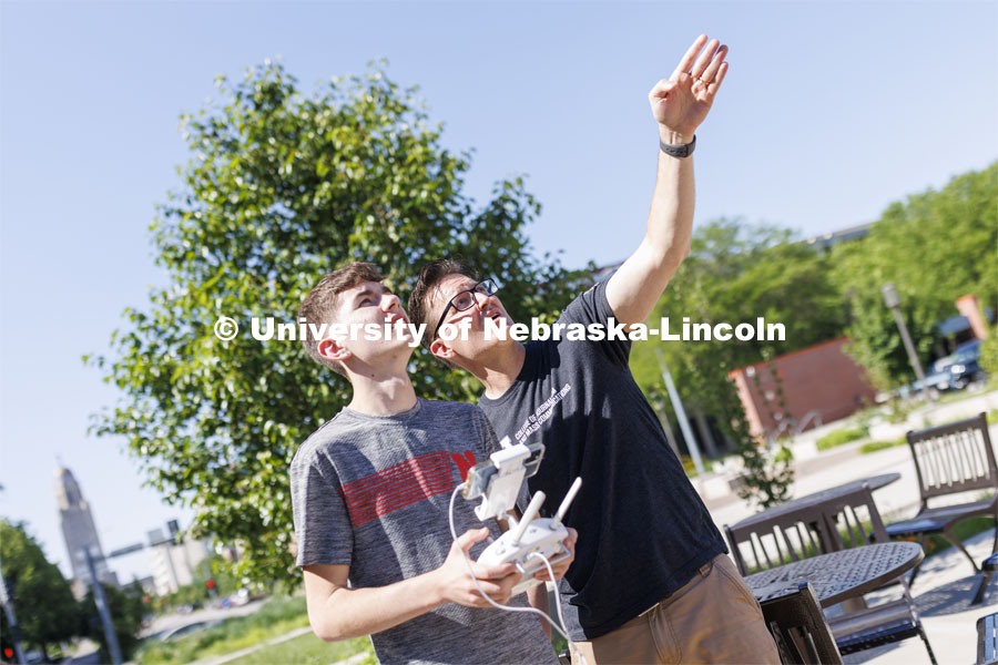 Journalism professor Matt Waite, coaches Xander Munson of Nebraska City as Munson flies a drone outside of Andersen Hall.  Munson and other high school students are on camps for the 4-H Digital Media Big Red Academic Camp. June 16, 2022. Photo by Craig Chandler / University Communication.