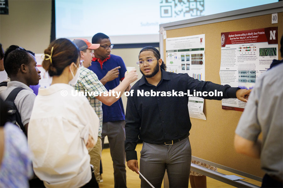 Deuris Pena Pena, from Bloomfield (New Jersey) College, describes his research on soybean genome editing. Poster fair for Nebraska Summer Research Program in Nebraska Union ballroom. August 5, 2022. Photo by Craig Chandler / University Communication.