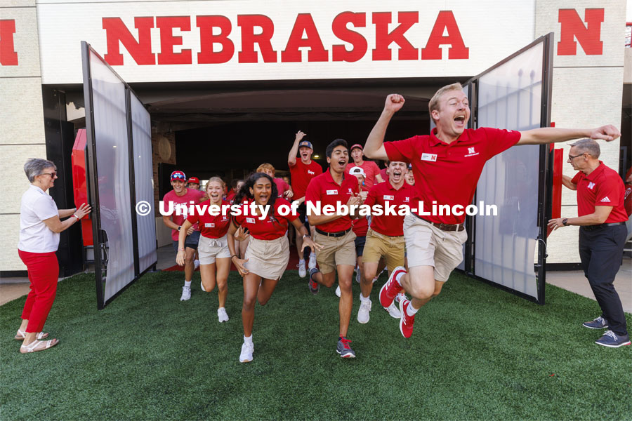 NSE Orientation Leader Jackson Anderson leads the new students out of the Tunnel Gates at the Tunnel Walk and New Student Welcome in Memorial Stadium. August 19, 2022. Photo by Craig Chandler / University Communication.