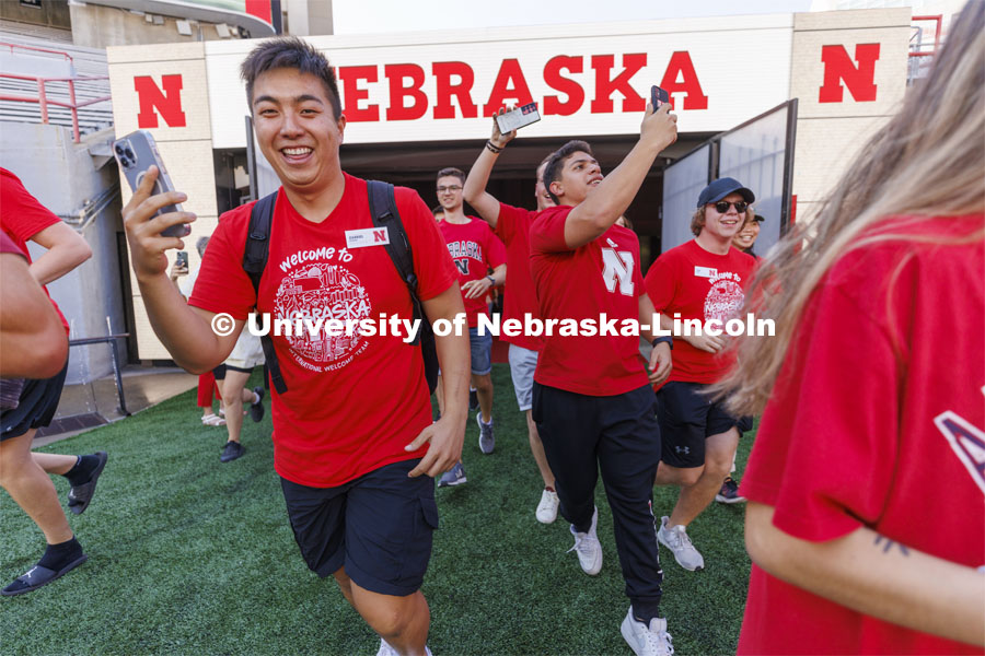 Students run out of the Tunnel Gates at the Tunnel Walk and New Student Welcome in Memorial Stadium. August 19, 2022. Photo by Craig Chandler / University Communication.