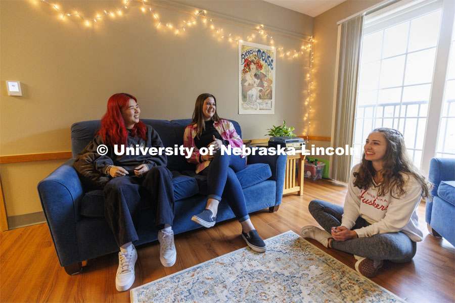 Students socializing in an apartment style room in The Courtyards Residence Hall. Housing Photo Shoot in The Courtyards Residence Hall. September 27, 2022. Photo by Craig Chandler / University Communication.