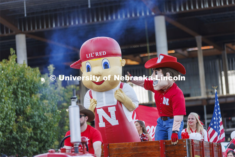 Lil’ Red and Herbie Husker wave to the crowd in from of the stadium. Homecoming Parade and Cornstalk. September 30, 2022. Photo by Craig Chandler / University Communication.