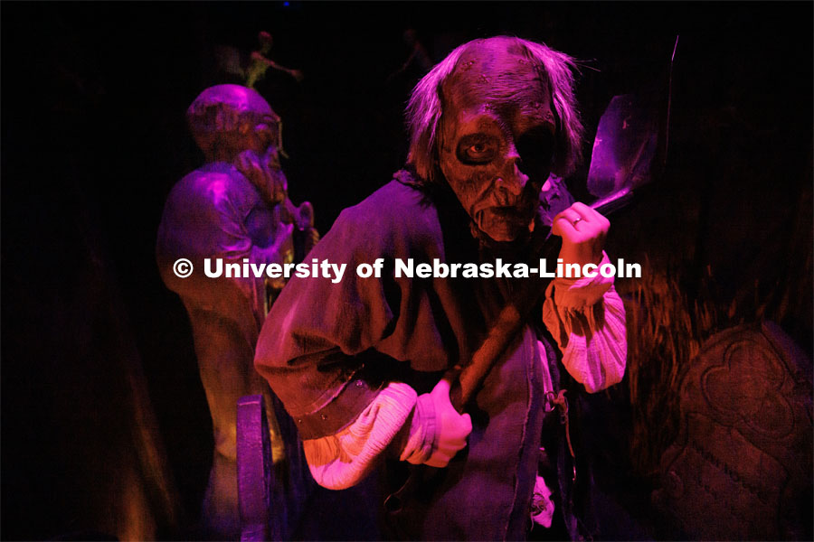 Jackson Wells performs as the Gravedigger as he awaits the next group to scare on a recent Friday evening. ShakesFear production in the Temple Building. October 21, 2022. Photo by Craig Chandler / University Communication.