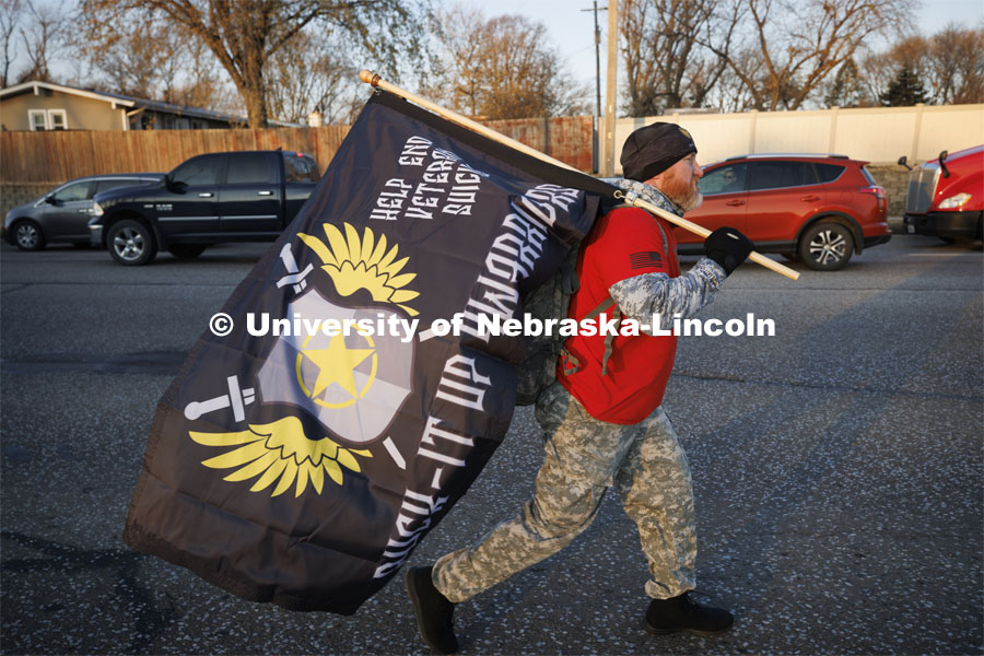 Scott Fredenburg, a retired Army veteran and leader of Ruck-It-Up Warriors, walks in the ruck march. Nebraska students and veterans march from Memorial Stadium Wednesday morning. "The Things They Carry" ruck march involving military and veteran students from Iowa and Nebraska. To raise awareness about veteran suicide, through the week, the students walk in 20-mile shifts carrying 20-pound backpacks to commemorate the estimated 20 veterans who die by suicide each day. November 15, 2022. Photo by Craig Chandler / University Communication.