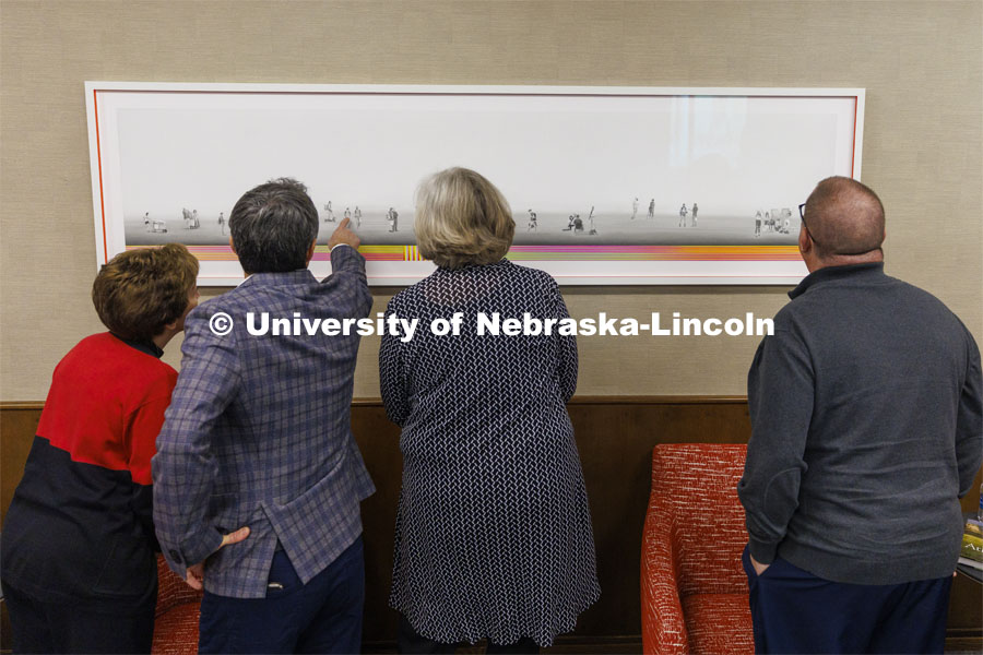 Francisco Souto (second from left) discusses "We Are Nebraska" with members of Chancellor Ronnie Green's executive leadership team. The artworks took 17 months to create and consists of graphite pencil drawings of students, professors and Chancellor Ronnie Green. November 21, 2022. Photo by Craig Chandler / University Communication.