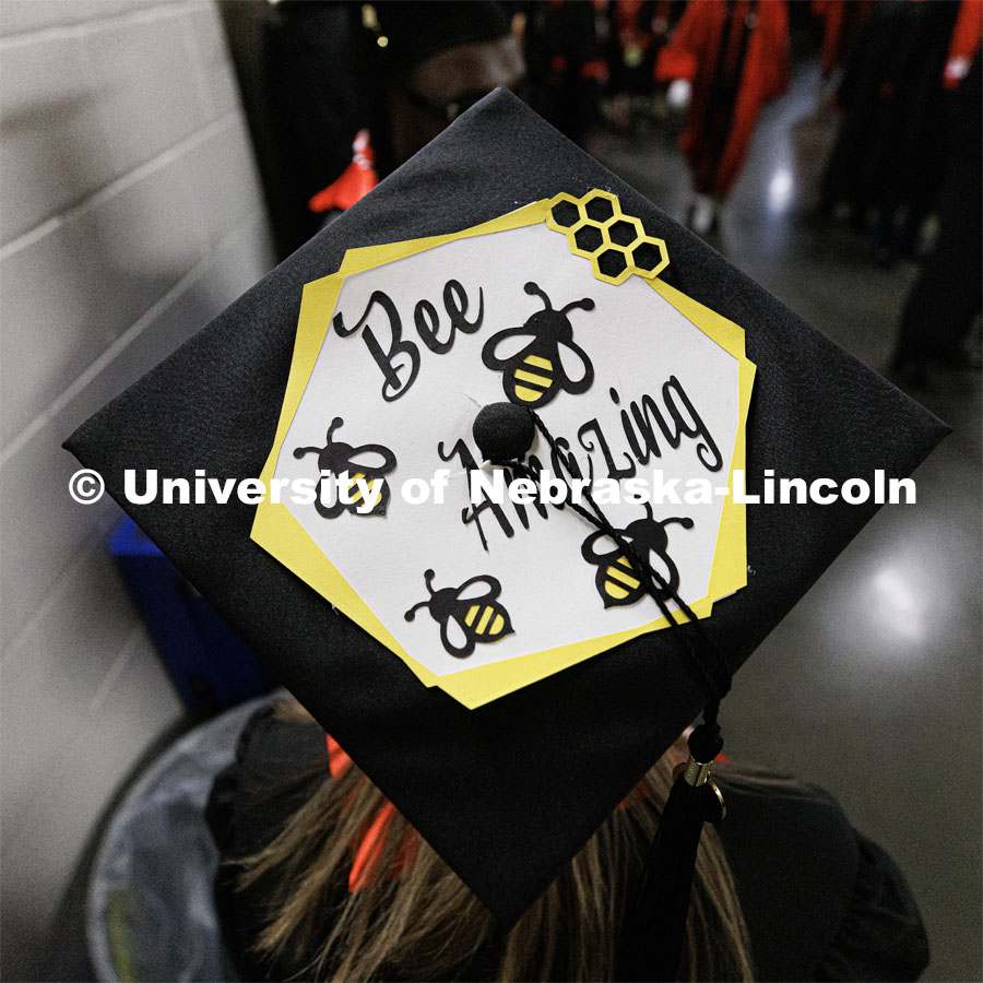 College of Business Management graduate Maggie Targy and her decorated mortar board. Winter Undergraduate Commencement in Pinnacle Bank Arena. December 17, 2022. Photo by Craig Chandler / University Communication.