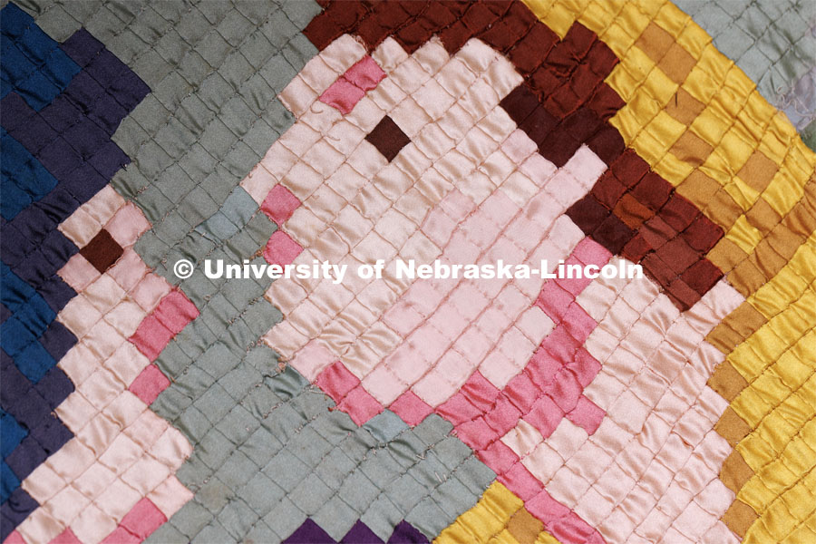 A closeup of  the Ruth and Naomi Quilt sewn by Charles Pratt in the 1930s. The quilt is comprised of 1/4 inch squares of fabric. Quilt Center. February 8, 2023. Photo by Craig Chandler / University Communication.