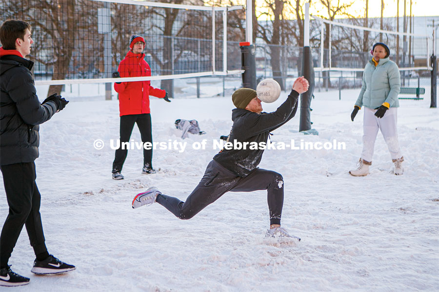 UNL students plays volleyball with friends on Thursday outside the Harper Schramm Smith residence halls.  Feb. 16, 2023. Photo by Sammy Smith for University Communication
