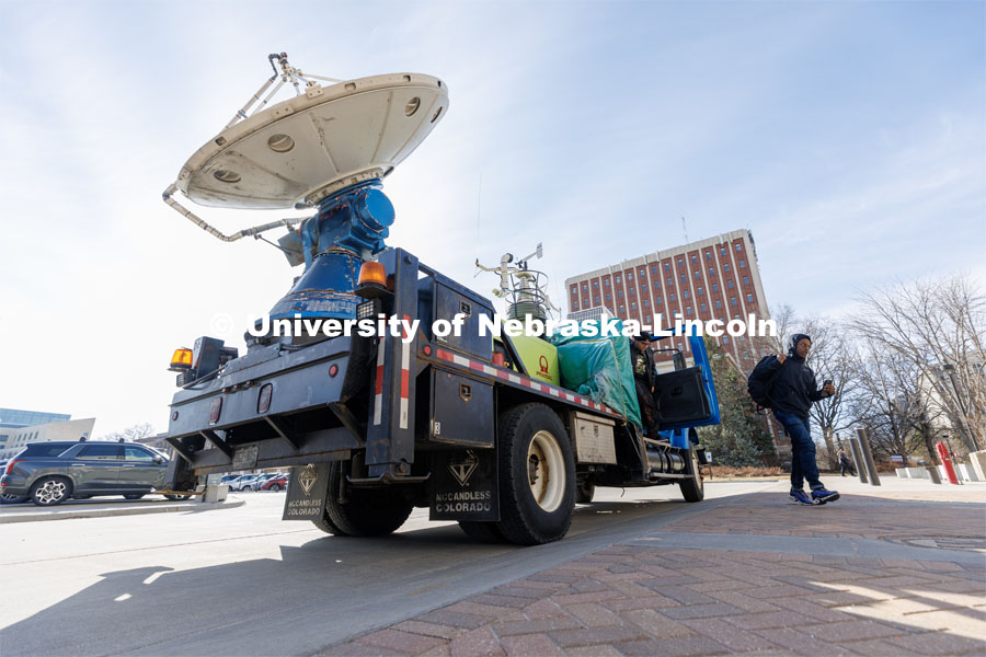Students hop out of The Doppler on Wheels, part of the Flexible Array of Radars and Mesonets operated by the University of Illinois. The radar truck is on campus this week so Adam Houston’s TORUS team can train with it. The DOW is also being demonstrated to the meteorology students. March 20, 2023. Photo by Craig Chandler / University Communication.