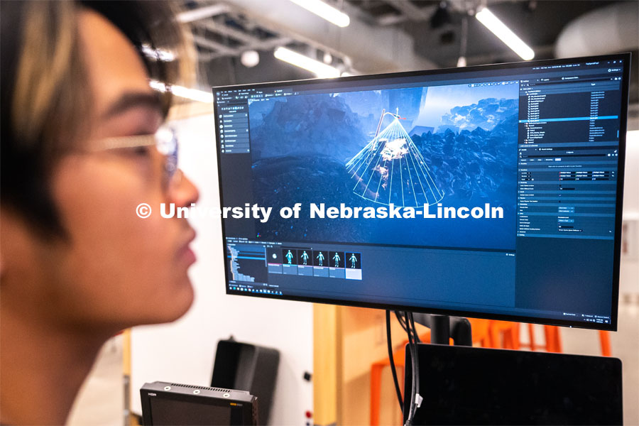 Sophomore emerging media arts major Xander Muniz adjusts a light inside an environment in Unreal Engine that will be displayed on a screen. Johnny Carson Center for Emerging Media Arts. April 9, 2023. Photo by Jordan Opp for University Communication.