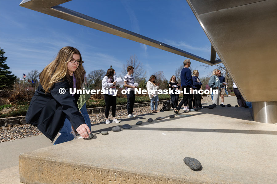 Annalyse Gallo, a sophomore from Chicago, places a rock on the Holocaust Memorial. In Jewish cemeteries, the tradition is to place rocks on the grave rather than flowers.
History of the Holocaust course students visit the Holocaust memorial in Lincoln’s Wyuka Cemetery. April 18, 2023. Photo by Craig Chandler / University Communication.
