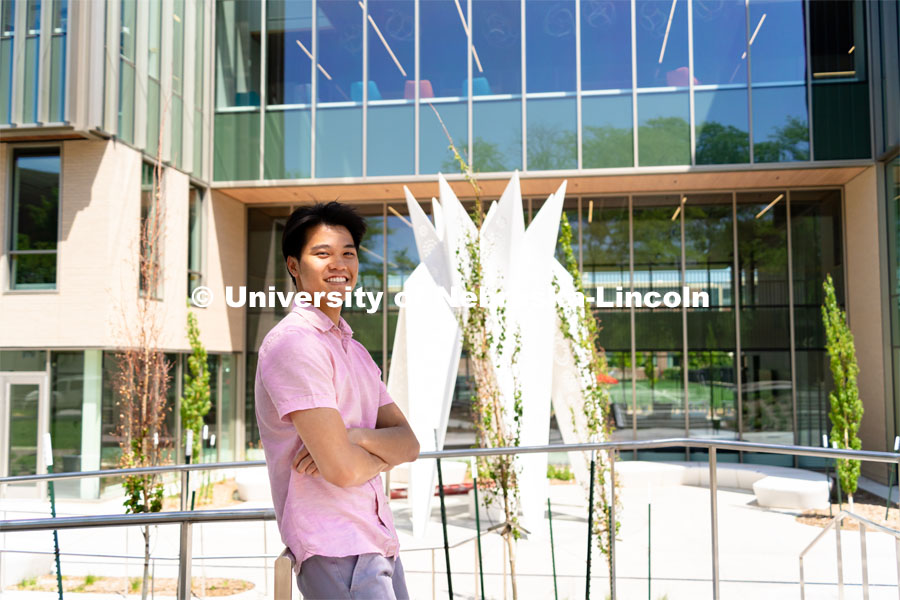 Andre Nguyen, Junior in Nutritional Science and Dietetics, smiles for a photo outside the Gwendolyn A. Newkirk Human Sciences Building. APIDA Heritage Month Feature. He is also a member of DMNV Lion Dance. May 16, 2023. Photo by Jonah Tran for University Communication