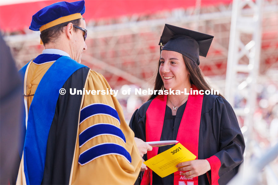 Isabel Adrover Gallego receives her diploma. Undergraduate commencment at Memorial Stadium. May 20, 2023. Photo by Craig Chandler / University Communication.