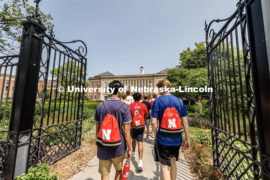 The campus tour takes the group through the gates of the Love Gardens. New Student Enrollment ( NSE ) on City Campus. June 13, 2023. Photo by Craig Chandler / University Communication.