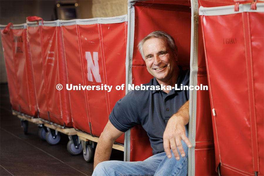 Larry Shippen, Director, Housing Facilities Operations, is geared up for the housing move in which begins the week of August 13th. Larry is pictured sitting in one of the moving carts. August 4, 2023. Photo by Craig Chandler/ University Communication.