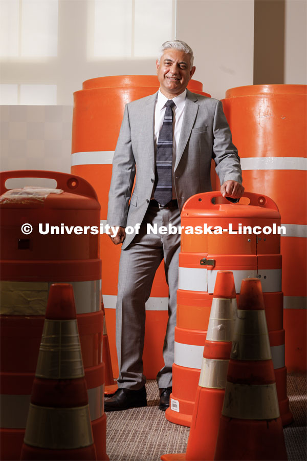 Aemal Khattak, Director of the Mid-America Transportation Center is surrounded by a bunch of traffic cones and barrel barricades. August 11, 2023. Photo by Craig Chandler/ University Communication. 