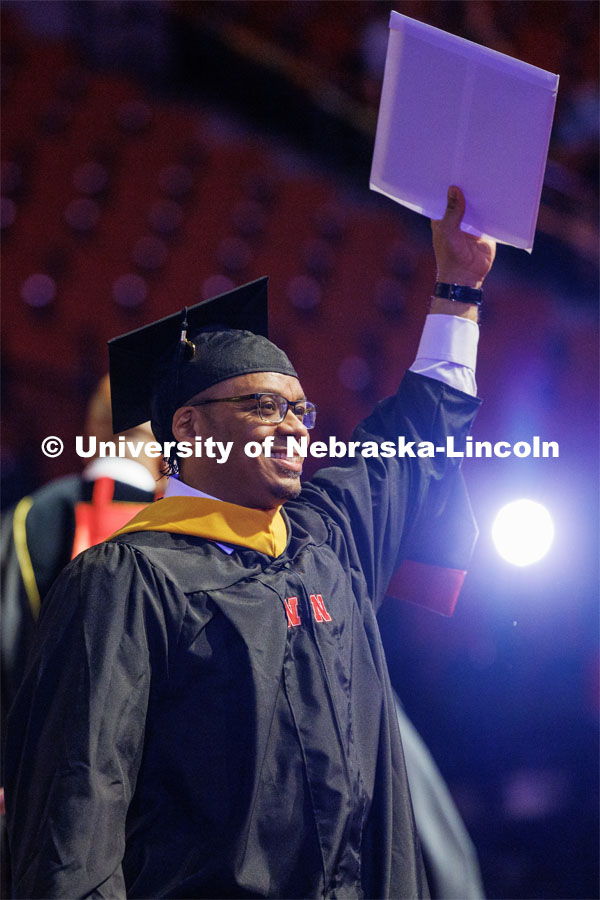 Fyiad Constantine waves to family and friends after receiving his masters degree. The University of Nebraska–Lincoln is conferring 588 degrees during the combined graduate and undergraduate commencement ceremony at Pinnacle Bank Arena. August 12, 2023. Photo by Craig Chandler/ University Communication.