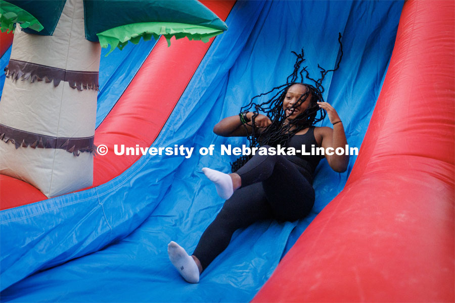 Students slide down the inflatables at the Block party at Harper Schramm Smith. August 17, 2023. Photo by Craig Chandler / University Communication.