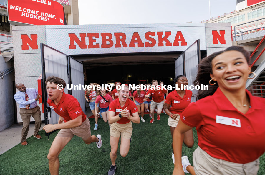 NSE leaders including Grace Charlesworth, center, lead the Class of 2027 onto the field during the Tunnel Walk in Memorial Stadium. August 18, 2023. Photo by Craig Chandler / University Communication.