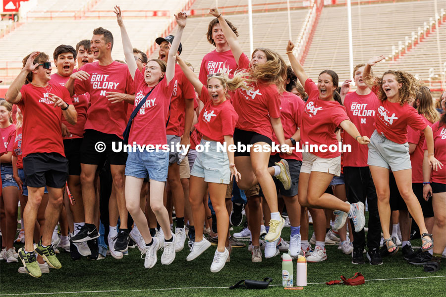Students leap for joy at the Tunnel Walk in Memorial Stadium. August 18, 2023. Photo by Craig Chandler / University Communication.