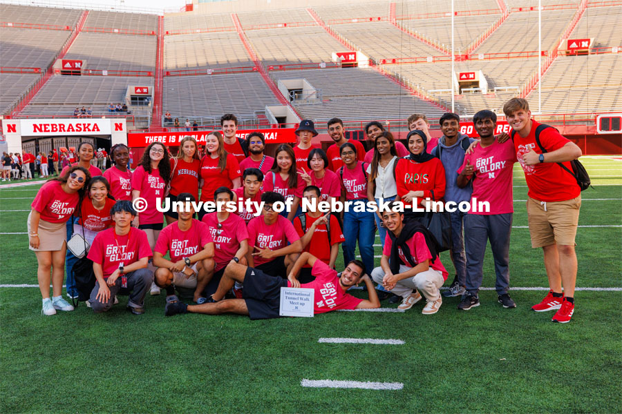 International students pose for a photo at the Tunnel Walk in Memorial Stadium. August 18, 2023. Photo by Craig Chandler / University Communication.