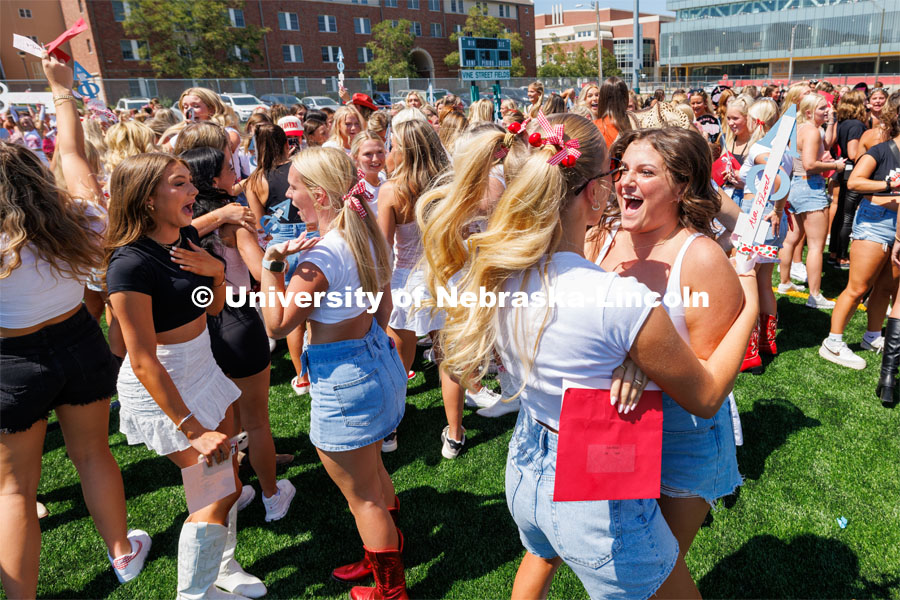 Ava Flood, right, greets her Alpha Phi big sister Izzy Jarecki. Sorority Bid Day in the Cather Dining Complex and on the Vine Street Fields. August 19, 2023. Photo by Craig Chandler / University Communication.