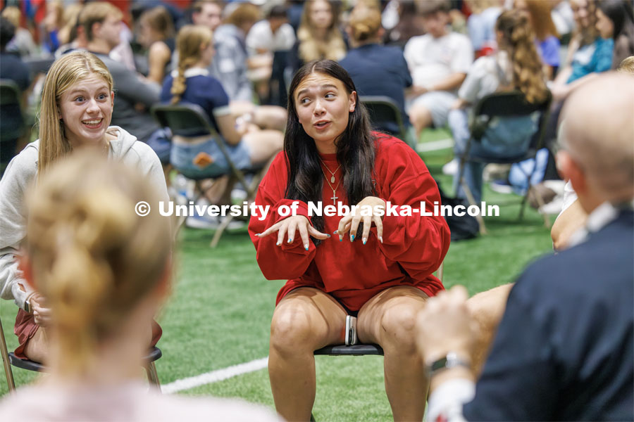 An expressive Bailey Ostlund of Omaha talks during a discussion on the best way of taking notes during class. Students sit in discussion circles during Husker Dialogues in the Coliseum and Cook Pavilion. September 6, 2023. Photo by Craig Chandler / University Communication.