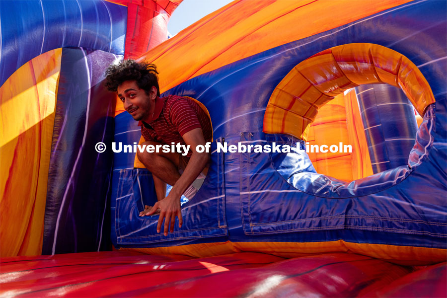 Savan Patel jumps through an inflatable obstacle course at Hanging with the Huskers event September 29, 2023. September 29, 2023. Photo by Dillon Galloway for University Communications.
