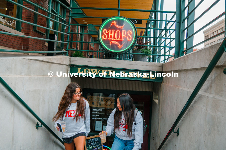 Grace Patel (left) and Isela Tercero browse shops in the Haymarket. About Lincoln at Coffee Shops in the Haymarket. October 17, 2023. Photo by Matthew Strasburger / University Communication.