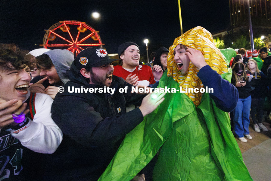 James Lynch with Phi Kappa Psi is mobbed by his friends after winning the jester competition. Homecoming parade and Cornstock. October 27, 2023. Photo by Craig Chandler / University Communication.