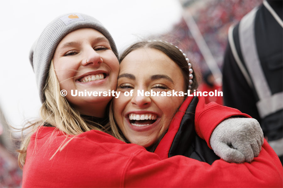 Lydia Storm is hugged by a friend after the homecoming ceremony. Nebraska football versus Purdue Homecoming game. Seniors Hannah-Kate Kinney of Omaha and Preston Kotik of Hooper have been crowned homecoming royalty at the University of Nebraska–Lincoln. October 28, 2023. Photo by Craig Chandler / University Communication.