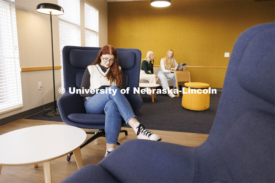 Sarah Danahy, left, Madalyn Schoneman and Alexis Tenorio study in the Knoll Residential Center lounge. A University of Nebraska–Lincoln team’s proposed renovation of a little-used TV lounge in the Robert E. Knoll Residential Center features multiple study spaces designed to allow for collaboration between students won the 2019 Big Ten Academic Alliance Student Design Challenge. Following pandemic delays, the furniture has been delivered. The annual contest, supported by the Herman Miller furniture company, allows students to develop and pitch a renovation of an existing campus space. November 17, 2023. Photo by Craig Chandler / University Communication and Marketing.