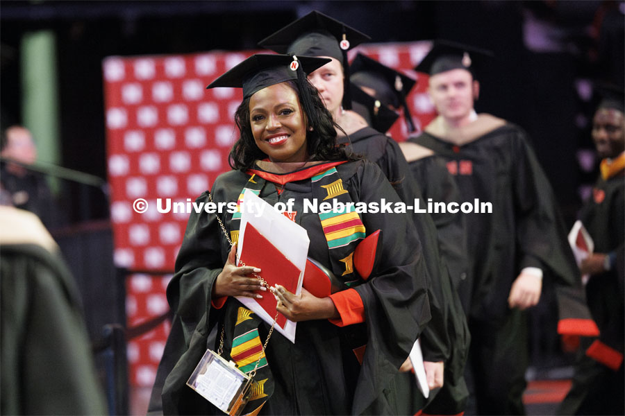 Marlenia Jewell Thornton walks during the recessional. Graduate Commencement at Pinnacle Bank Arena. December 15, 2023. Photo by Craig Chandler / University Communication and Marketing.