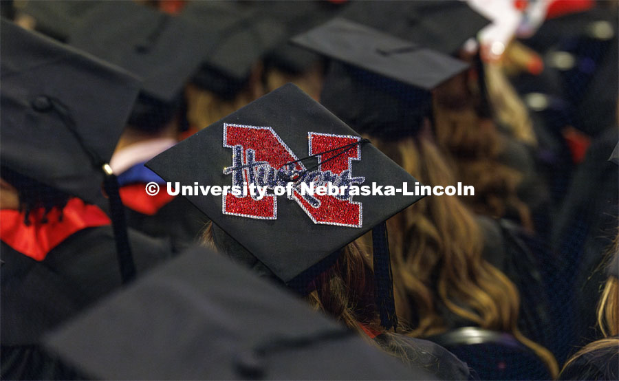 Decorated mortarboard at undergraduate commencement in Pinnacle Bank Arena. December 16, 2023. Photo by Craig Chandler / University Communication and Marketing.
