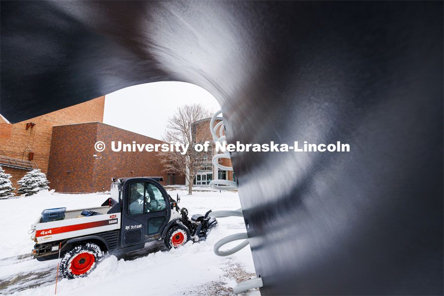 Tavian Tank with landscape services clears snow on the sidewalks between the Torn Notebook and the Visitors Center. Tank was on campus at 4 am to start pushing snow. Snow on city campus. January 9, 2024. Photo by Craig Chandler / University Communication and Marketing.