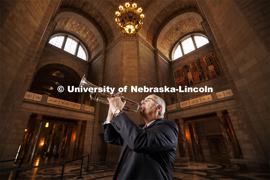 Nebraska State Senator Robert Clements (’73) was a trumpet player in the Cornhusker Marching Band and plays yearly with the alumni band. Clements is pictured in the State Capitol with his trumpet. Photo for Nebraska Alumni magazine. January 18, 2024. Photo by Craig Chandler / University Communication and Marketing.