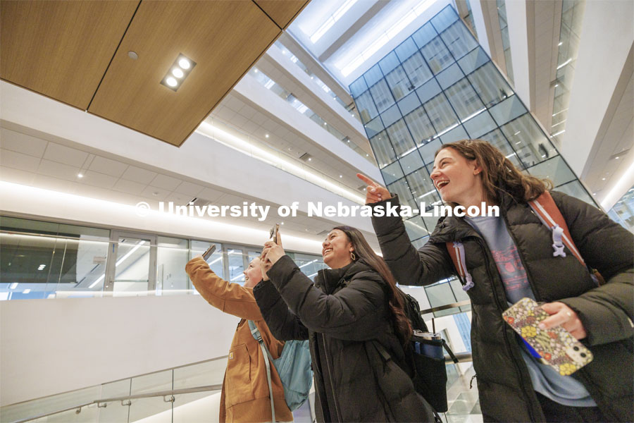 Civil Engineering sophomores, from left, Meghan Murphy, Fatima Pilar-Solis, and Miriam Huss photograph friends as they go to their first class in Kiewit Hall. January 22, 2024. Photo by Craig Chandler / University Communication and Marketing.