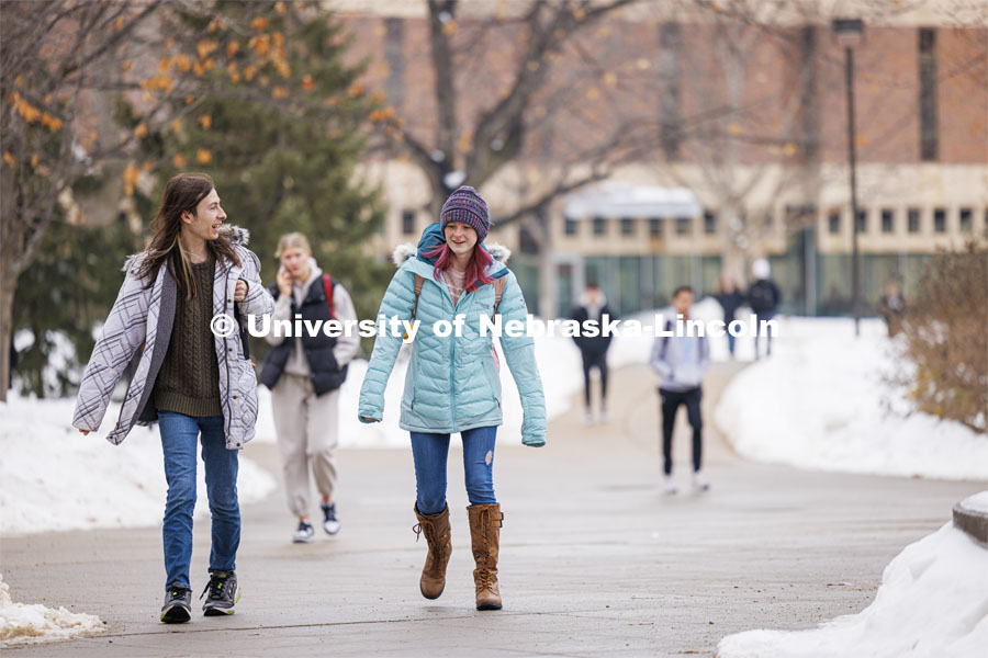 Elijah Brundage, left, and Ellie Fox walk across campus Tuesday. Snow on city campus. January 23, 2024. Photo by Craig Chandler / University Communication and Marketing.