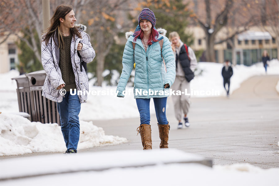 Elijah Brundage, left, and Ellie Fox walk across campus Tuesday. Snow on city campus. January 23, 2024. Photo by Craig Chandler / University Communication and Marketing.