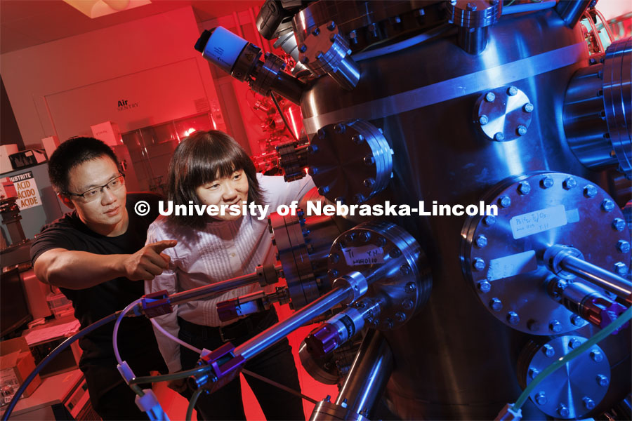Xia Hong, right, and Yifei Hao look into a pressure vessel in Hong’s Jorgensen Hall lab. Hong’s team has developed a new material design for transistors that could help downsize next-gen electronic devices. January 24, 2024. Photo by Craig Chandler / University Communication and Marketing