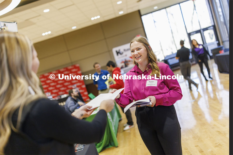 Ainsley Fischer talks with a recruiter from Frontier Cooperative at the East Campus Career Fair. February 8, 2024. Photo by Craig Chandler / University Communication and Marketing.