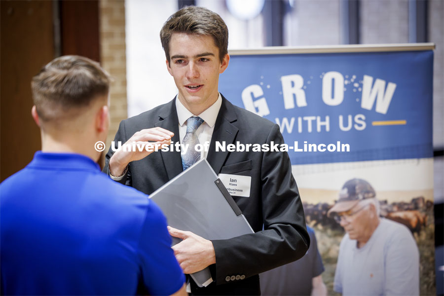 Ian Klaes talks with a recruiter from Farmers Cooperative in Dorchester, NE, at the East Campus Career Fair. February 8, 2024. Photo by Craig Chandler / University Communication and Marketing.