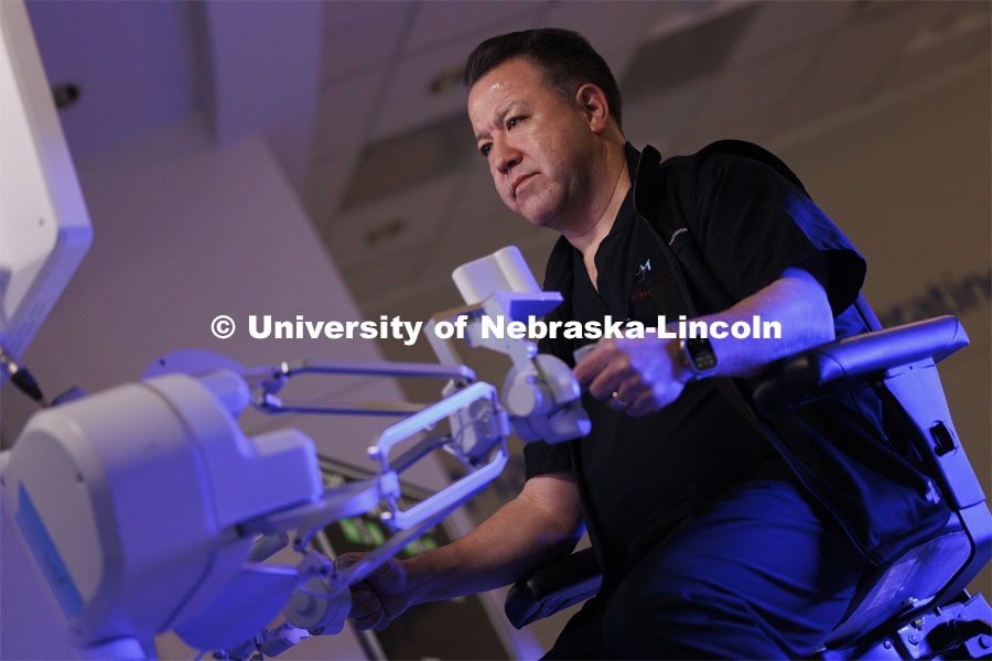 Dr. Michael Jobst, a colorectal surgery specialist in Lincoln, NE, concentrates making the first surgical robotic cuts on the International Space Station. Controlled from the Virtual Incision offices in Lincoln, NE, surgeons cut rubber bands–mimicking surgery–inside a payload box on the International Space Station. February 10, 2024. Photo by Craig Chandler / University Communication and Marketing.