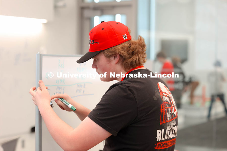 Volunteer, Nate Lind from Omaha, NE helping track scores. 2024 VEX Robotics Outreach Tournament hosted in Kiewit Hall. February 10, 2024. Photo by Taryn Hamill for University Communication and Marketing.