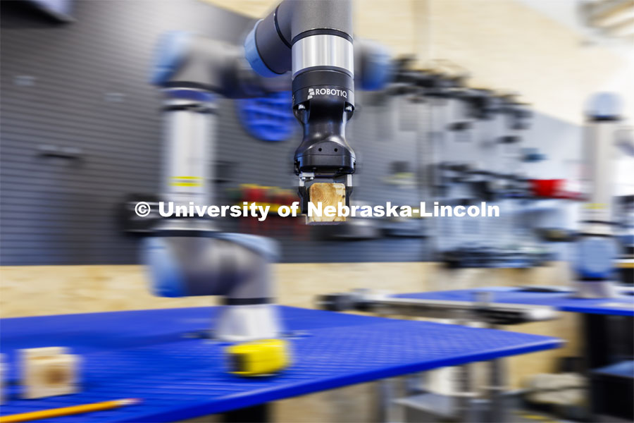 A robotic arm is programmed to stack blocks at Nebraska Innovation Studio. The robot’s programming would simulate a larger robotic arm stacking pallets. Nebraska Innovation Studio is working with robotic arms and teaching students and local industry people how to use them. February 20, 2024. Photo by Craig Chandler / University Communication and Marketing.