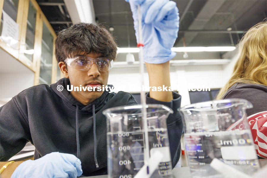 Abhi Karri checks the temperature on a beaker of water. LIFE 120L - Fundamentals of Biology lab in Manter Hall. February 22, 2024. Photo by Craig Chandler / University Communication and Marketing.