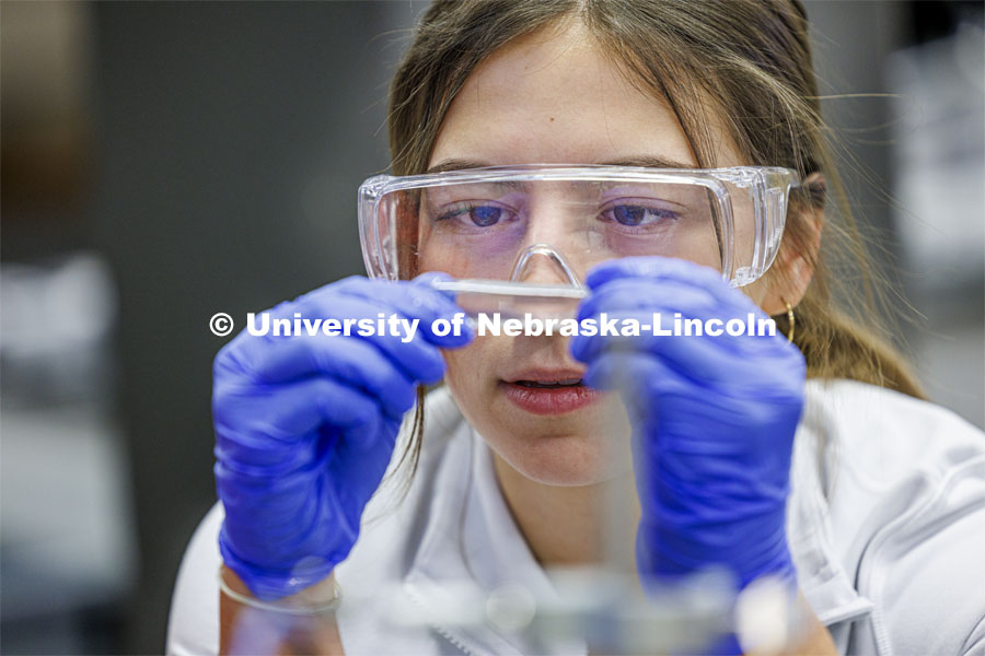 Grace Henry looks at a fluid sample. LIFE 120L - Fundamentals of Biology lab in Manter Hall. February 22, 2024. Photo by Craig Chandler / University Communication and Marketing.